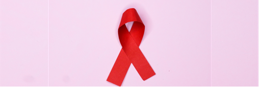Red HIV ribbon on a pink background