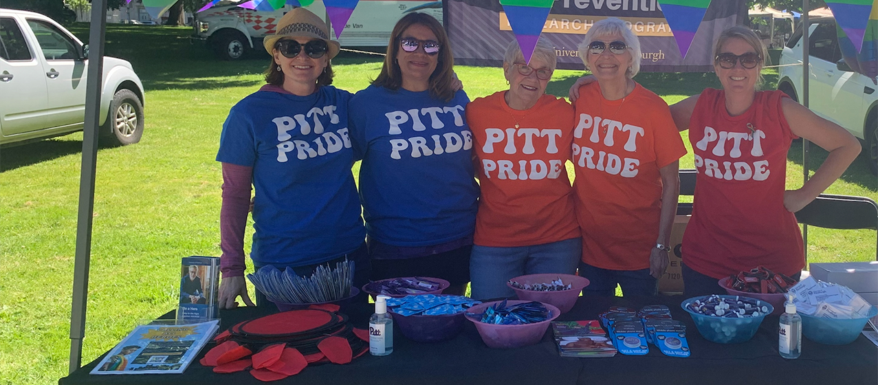 Image of 5 women underneath a canopy wearing a Pitt Pride t-shirt